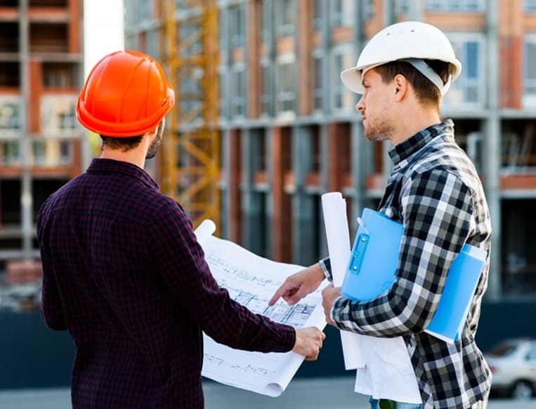 Professional engineers and construction team discussing building materials project in Saudi Arabia
